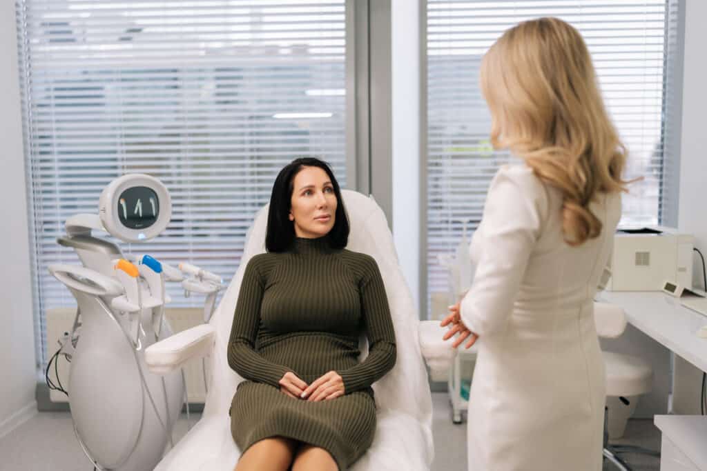 Client discussing non-surgical cosmetic treatment options with an aesthetic provider
