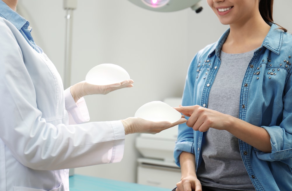 Woman in consultation with surgeon to discuss implant option and feeling positive